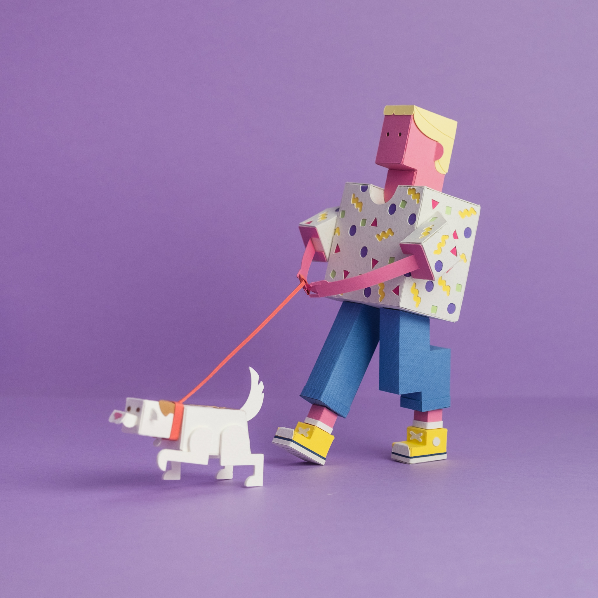 Paper toy of a person walking a dog