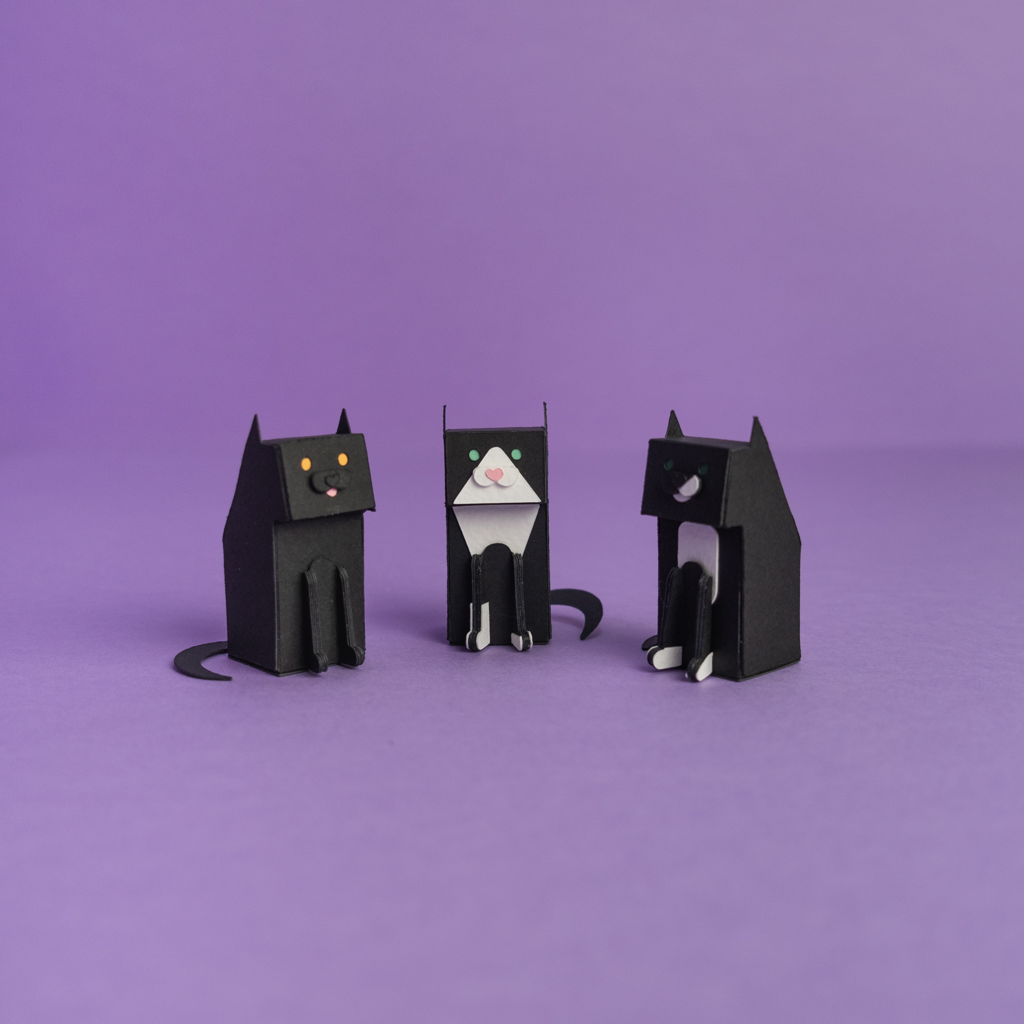 Three paper toys of cats