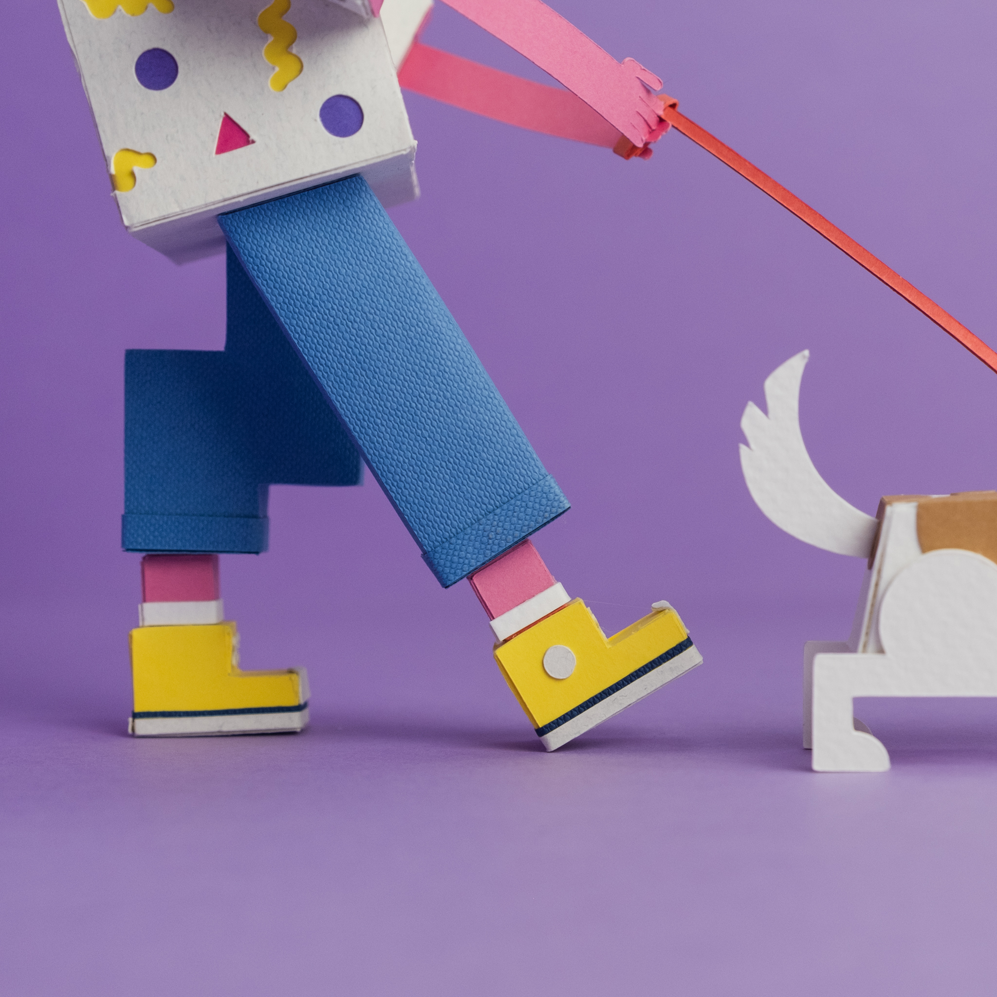 Paper toy of a person walking a dog