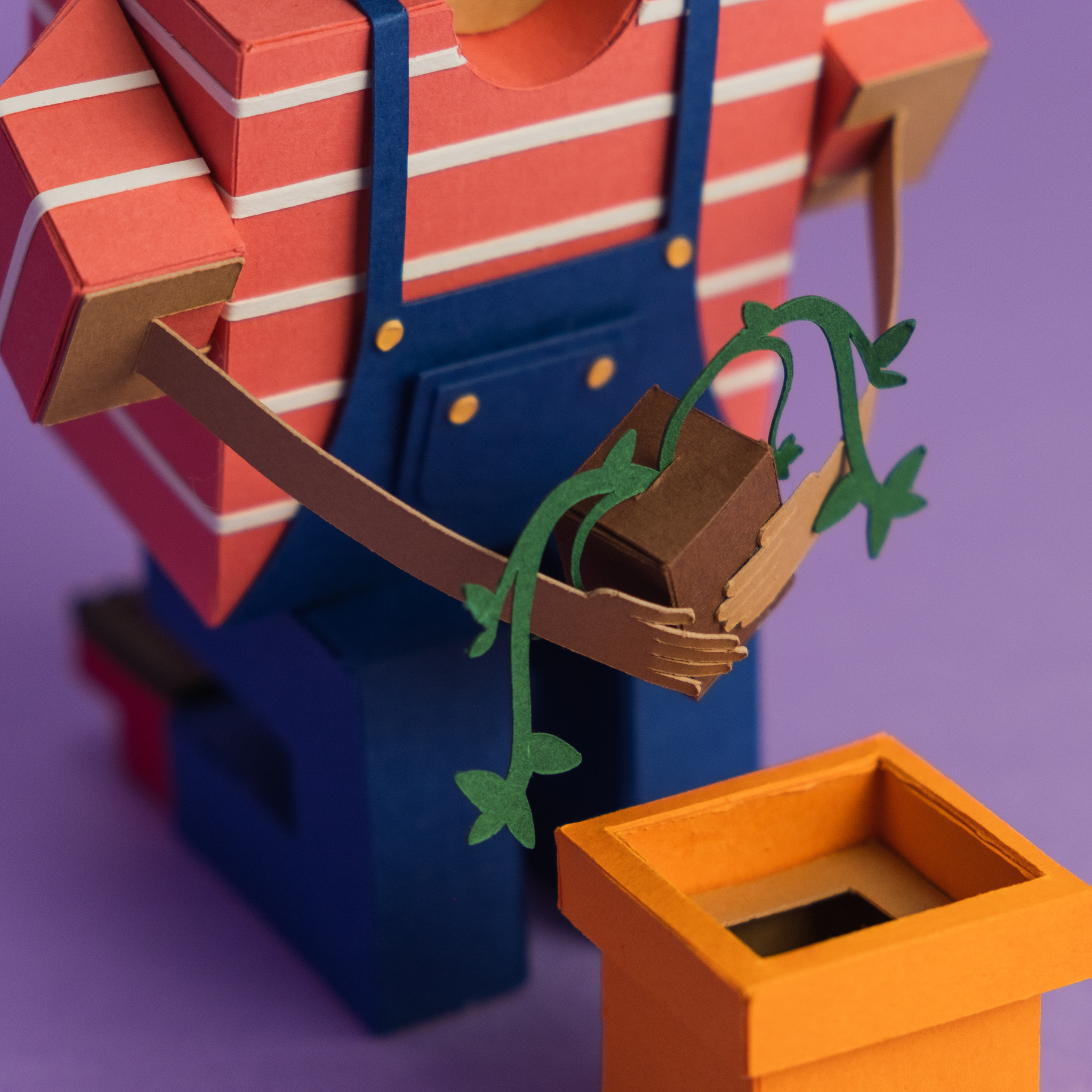 Paper Toy of a person holding a plant detail